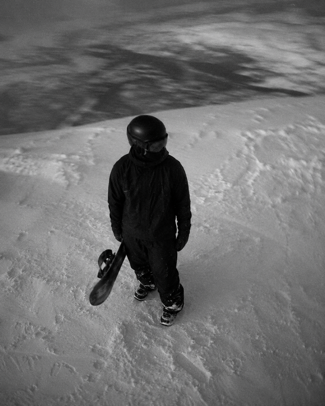 Hooded figure exhaling into charged air